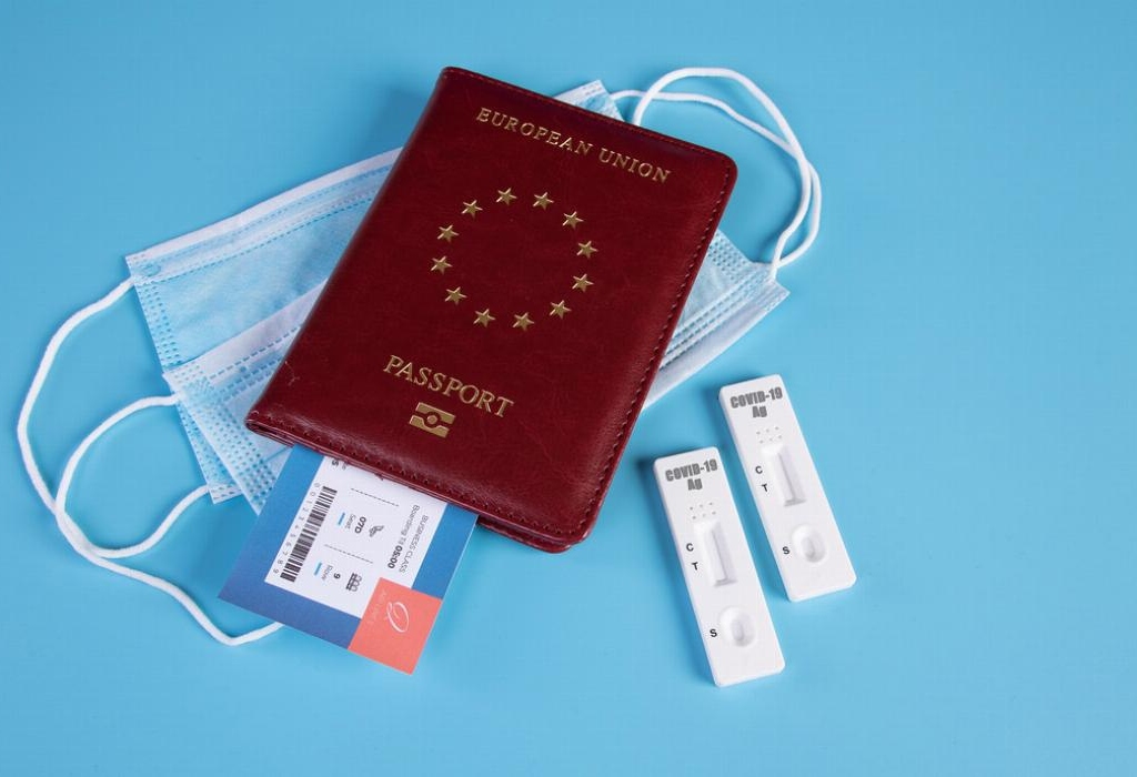 European Union Passport with airline ticket on a face mask, COVID-19 antigen test. Jernej Furman